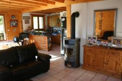 Chalet La Perriere - The open plan living room with log burner